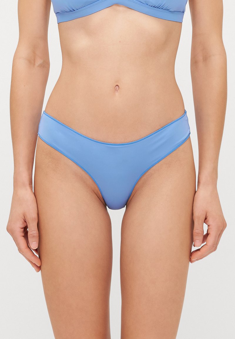 Blue bikini bottom made of smooth, stretchy material. Features a low-rise fit with minimal coverage and a simple stitched edge.