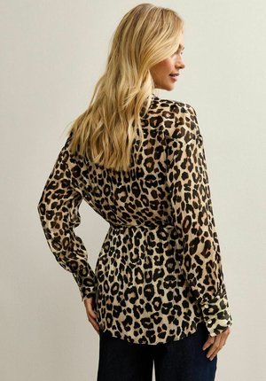 Leopard print blouse featuring a lightweight, sheer fabric with long sleeves, a cinched waist, and buttoned cuffs.