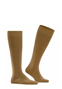 Calze al ginocchio di colore marrone chiaro, realizzate in un materiale liscio e elastico con texture a coste nella parte superiore e corpo uniforme.