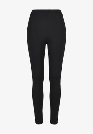 Juodos tamprės, pagamintos iš elastingos medžiagos, su aukštu juosmeniu ir dailiu siluetu. Lygus audinys be matomų raštų ar akcentų.