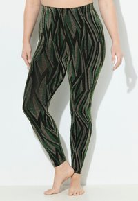 Leggings verts et noirs avec un motif en zigzag et des accents métalliques. Fabriquées en matériau extensible, elles disposent d'une taille élastique.
