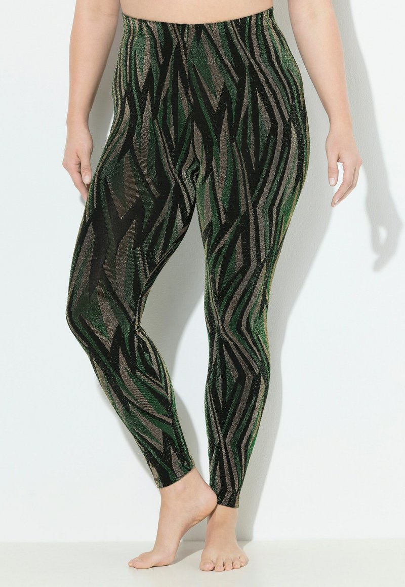 Leggings verts et noirs avec un motif en zigzag et des accents métalliques. Fabriquées en matériau extensible, elles disposent d'une taille élastique.