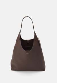 Brown leather tote bag with a curved silhouette, single handle, snap closure, and subtle logo detail on the front. Smooth texture.
