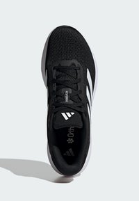 Schwarzer Sportschuh mit einem atmungsaktiven Mesh-Obermaterial, Schnürsenkeln und drei weißen Streifen an der Seite. Ausgestattet mit einer Ortholite-Einlegesohle und einer gepolsterten Sohle.