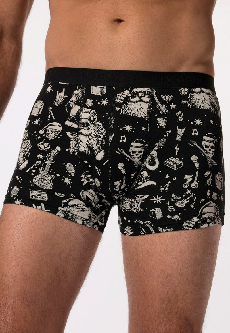Boxer shorts noirs ornés de diverses graphismes blancs, notamment des crânes, des guitares et des éléments musicaux, fabriqués à partir d'un matériau doux avec une taille confortable.