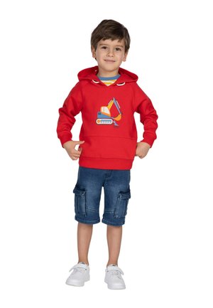 Red hoodie with a yellow and blue excavator graphic, paired with denim cargo shorts and white sneakers. Smooth fabric, practical design.