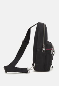 Borsa a tracolla sintetica nera con dettagli in rete, dotata di un compartimento principale con zip, tasca frontale con zip e spallaccio regolabile. Dettagli in metallo argentato.
