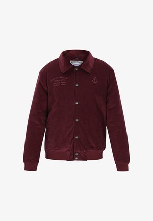 Burgunderfarbene Cord-Jacke mit Druckknopfverschluss, Kragen, zwei Seitentaschen und gesticktem Ankerdetail auf der Brust.
