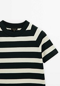 Striped t-shirt in dark green and cream, featuring short sleeves, round neckline, ribbed texture, and evenly spaced horizontal stripes.