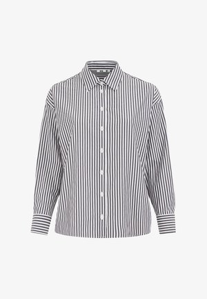 Koszula zapinana na guziki w pionowe czarne i białe paski, klasyczny kołnierz, długie rękawy i luźny krój. Posiada pięć białych guzików z przodu.