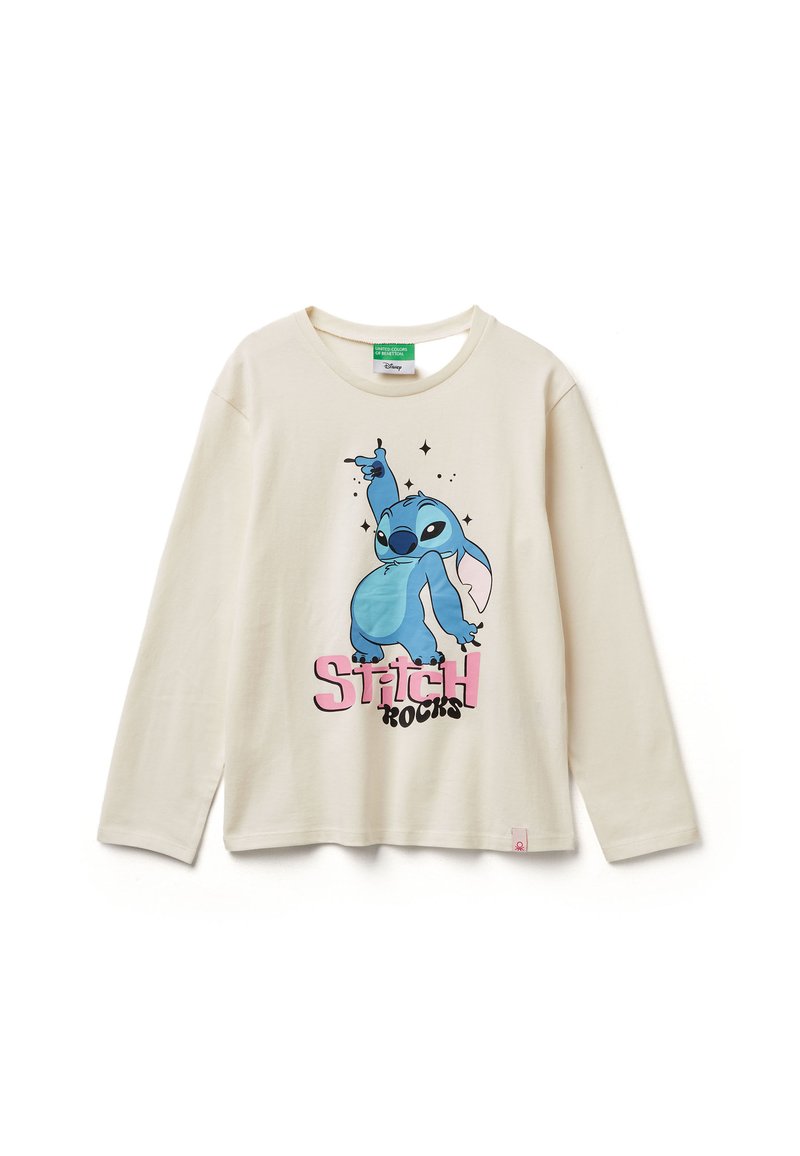 Dlouhá tričko krémové barvy s grafickým motivem modré kreslené postavičky a textem "Stitch Rocks" v růžové a černé. Lehký bavlněný materiál.