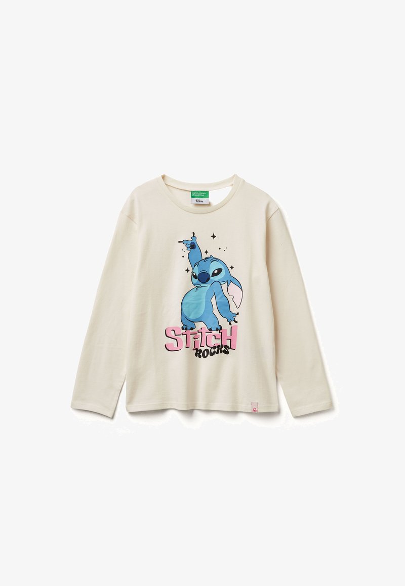 Dlouhá tričko krémové barvy s grafickým motivem modré kreslené postavičky a textem "Stitch Rocks" v růžové a černé. Lehký bavlněný materiál.