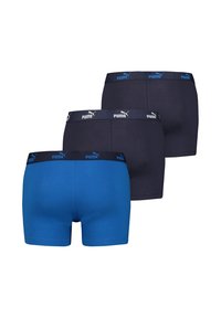 Blaue und marinefarbene Boxer-Shorts aus Baumwolle. Sie verfügen über einen breiten elastischen Bund mit einem Logo, eine glatte Textur und eine enganliegende Passform.