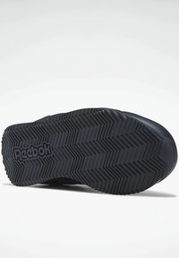 Svart gummisula till sko med ett zickzackmönster och Reebok-logotyp. Har robust konstruktion och texturerad yta för bättre grepp.