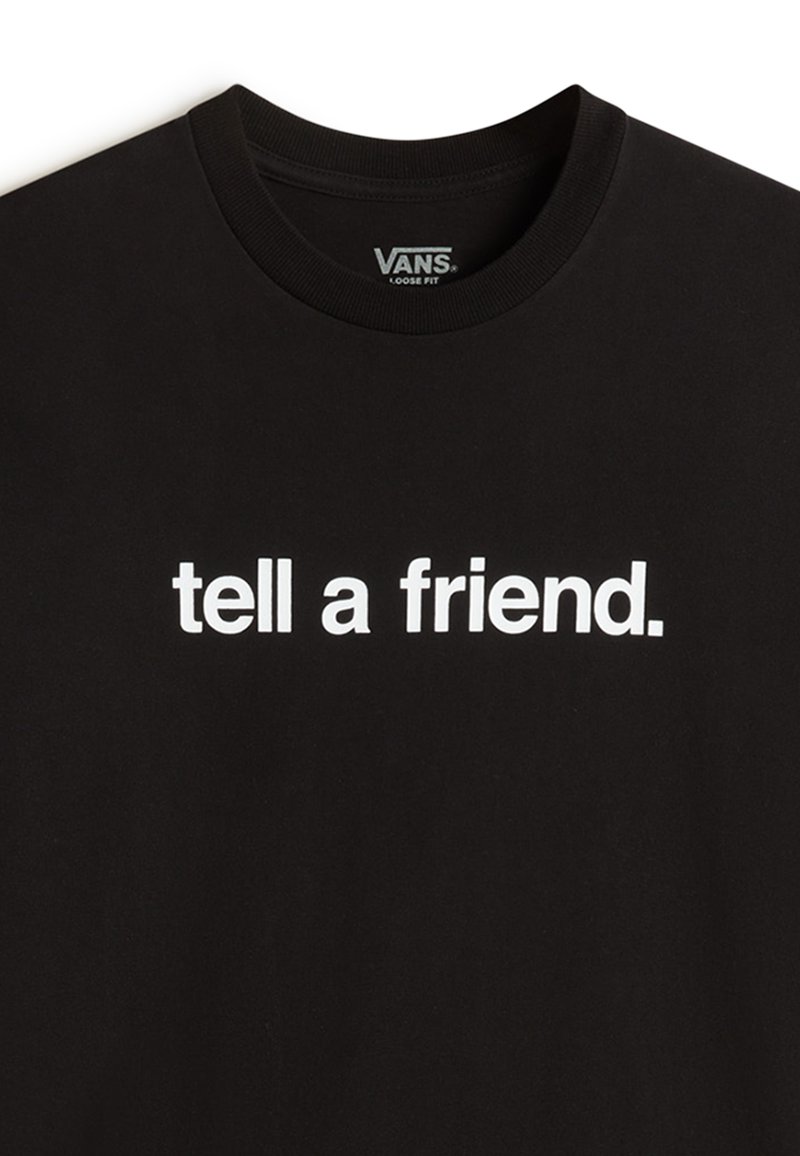 T-shirt en coton noir avec un col rond, arborant un texte blanc en gras "dis à un ami" et un design ample.