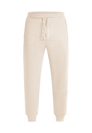 Beige joggingsbroek gemaakt van gestructureerd materiaal, met een elastische tailleband en trekkoord, zijzakken en ribgebreide manchetten.