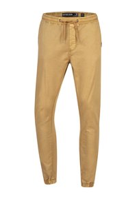 Beżowe spodnie dresowe w stylu slim-fit z elastyczną talią, sznurkiem, bocznymi kieszeniami i elastycznymi mankietami.