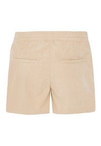 Short en velours côtelé beige avec taille élastique et deux poches arrière horizontales, vu de dos.