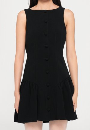 Robe noire sans manches avec un corsage ajusté, une patte de boutonnage devant et une jupe froncée évasée se terminant au-dessus des genoux.