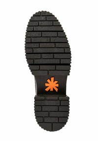 Semelle de chaussure noire avec un motif de semelle en brique et un logo en forme d'astérisque orange près du centre, sur un fond blanc.