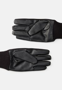 Gants en cuir noir avec une finition lisse, des poignets côtelés en tricot et un design ajusté.