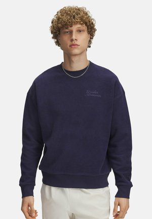Navy blue crewneck sweatshirt made from textured fabric, featuring ribbed cuffs and hem, with "Under Armour" embroidered on the chest.