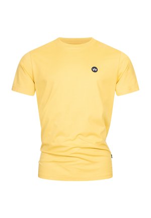 Yellow cotton t-shirt with a crew neckline, short sleeves, and a small black logo patch on the chest. Smooth texture, casual fit.