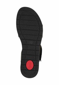 Černá gumová podrážka s hexagonálními vzory a červeným kruhovým emblémem s nápisem "Comfort." Flexibilní a plochý design pro snadné nošení.