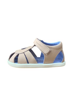 Sandalia beige de cuero para niños pequeños con interior acolchado azul, cierre de velcro, diseño de punta abierta y suela de goma blanca.