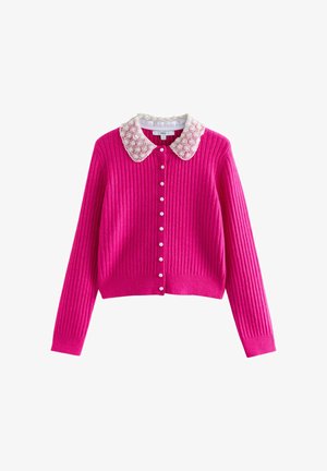 Fuchsia ribbed cardigan featuring a decorative white collar with circular fabric accents and pearl-like buttons at the front.