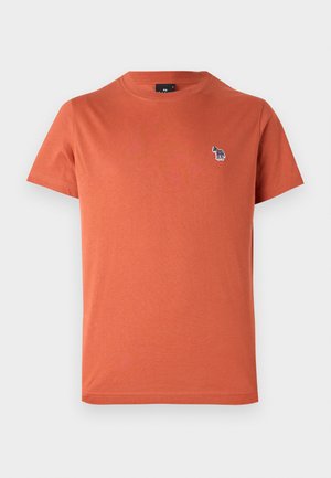 T-shirt en coton orange à manches courtes, col rond, avec un petit motif brodé multicolore sur la poitrine gauche.
