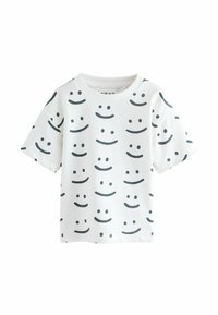 Hvid kortærmet t-shirt lavet af bomuld, med sorte smileyansigt mønstre i forskellige positioner, rund halsudskæring og en afslappet pasform.