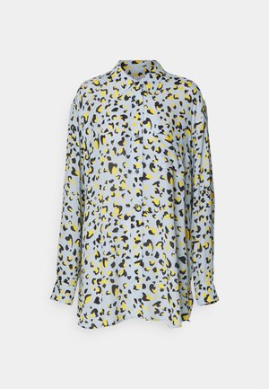 Light blue button-up shirt with leopard print in black and yellow, featuring a classic collar and long sleeves. Expansive fabric with a smooth texture.