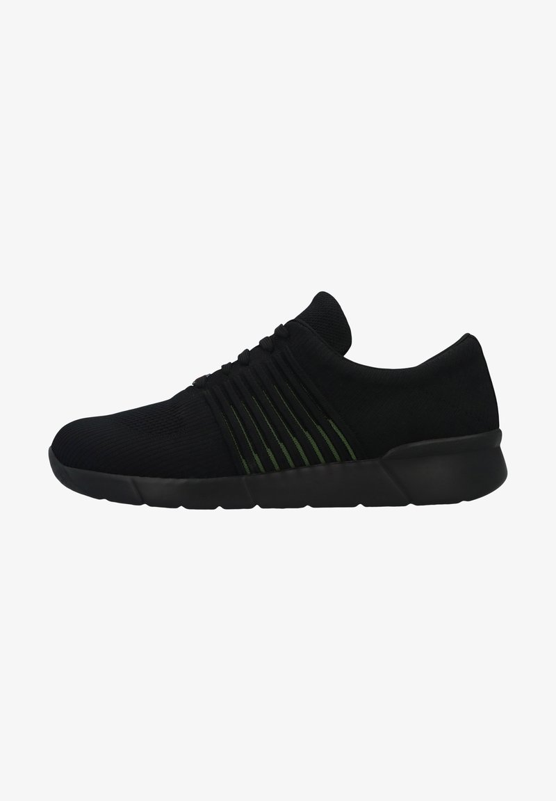 Black athletic shoes with a textured fabric upper, featuring green striped accents. The design includes a flexible rubber sole and no visible laces.