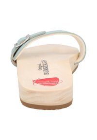 Two-tone wooden clog sandal with a light blue suede strap and metal buckle. Includes a natural wood footbed and beige rubber sole.