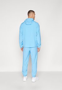 Nike Performance FORM PANT - Jogginghose - university blue/black/reflective silver