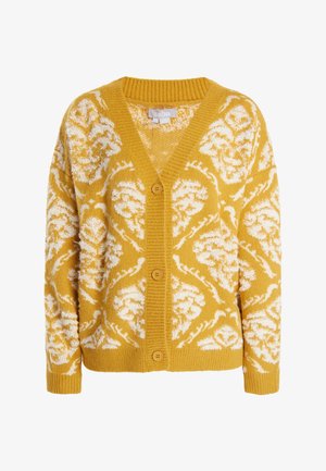Rumena jakna iz mehkega pletenega materiala, z belim cvetličnim vzorcem, V-izrezom, rebrastimi manšetami in tremi velikimi gumbi spredaj.