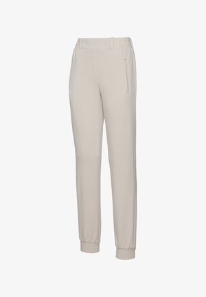 Lichtbeige joggers gemaakt van zachte stof. Kenmerken zijn taps toelopende benen, elastische boorden en een ritszak aan de zijkant voor opbergruimte.