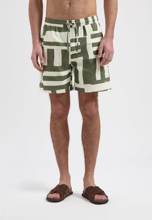 Heren shorts van lichtgewicht stof, met een groen en crèmekleurig abstract geometrisch patroon, een elastische tailleband en een volledige koordsluiting.
