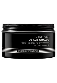 Pot noir rond avec une surface lisse. Étiqueté "Crème Pomade Maneuver", features des bandes et du texte argentés. Contient 3,4 fl oz (100 ml).