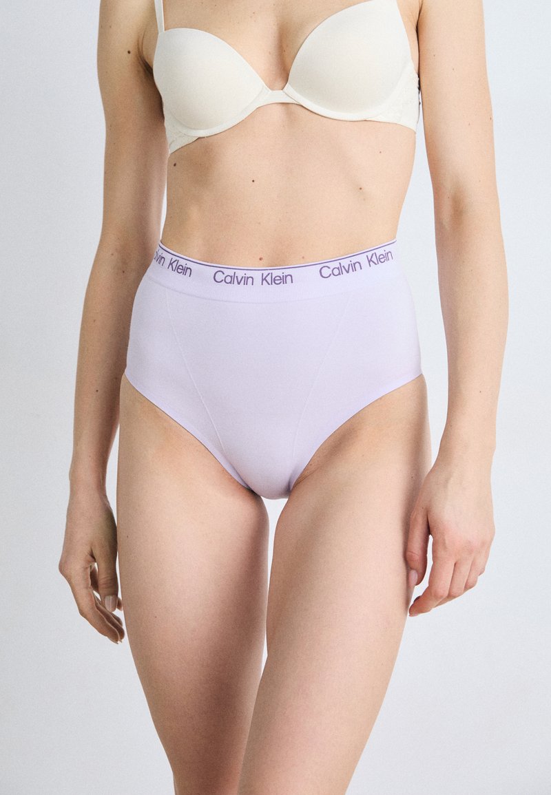 High-waisted lavender briefs with a smooth texture and elastic waistband featuring "Calvin Klein" logo in pastel purple.