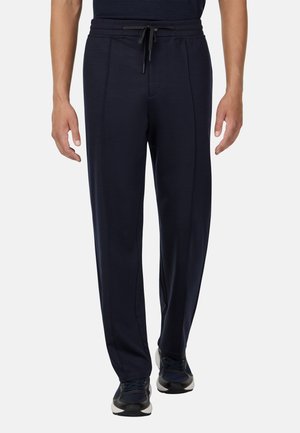 Pantalones deportivos navy con cinturilla elástica ajustable, costuras laterales y un corte ajustado, fabricados con un material suave adecuado para el uso casual.