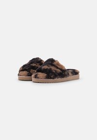 Faux fur slippers with a black and tan pattern, featuring a wide band design and a flat rubber sole for comfort.