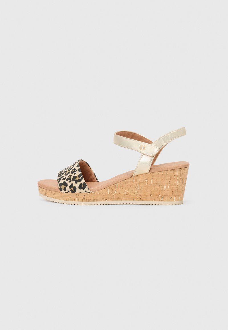 Sandália de cunha em padrão de leopardo com base de cortiça, correia de tornozelo dourada metálica e palmilha suave em bege. Design de bico aberto, acabamento texturizado.