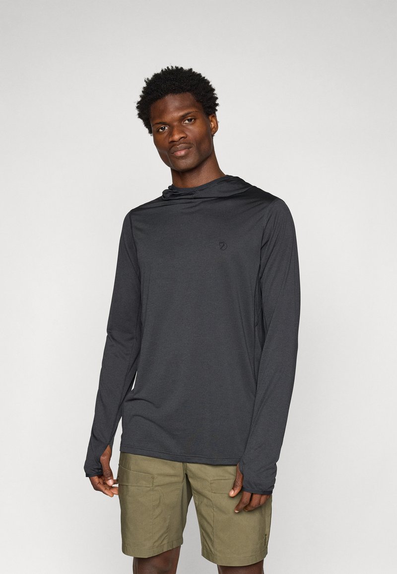 Long-sleeve black hoodie with a relaxed fit and hood, featuring a small logo on the chest. Worn with khaki shorts. Smooth fabric texture.
