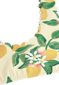 Sidrunimustriga kangas roheliste lehtede ja valgete lilledega. Omab servi, mille äärtes on lainelised jooned, ja heledat kollast tausta. Sile tekstuur.