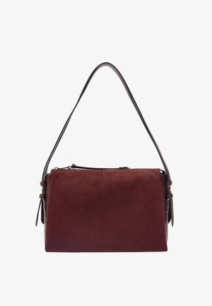 Bordowa torba z zamszu o sztywnej formie, brązowy skórzany pasek, zamek błyskawiczny oraz boczne akcenty umożliwiające regulację długości.