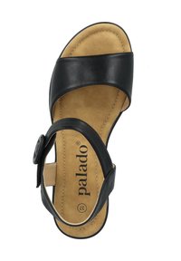 Sandalo in pelle nera con ampietti superiori, fibbia regolabile e soletta imbottita color tan. Nome del marchio "palado" stampato sulla soletta.