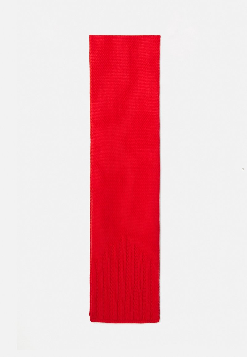Écharpe tricotée rouge vif avec motif côtelé à une extrémité, posée à plat sur un fond blanc.