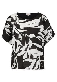 Blouse noire et blanche à manches courtes, coupe ample et grand motif abstrait de feuilles.